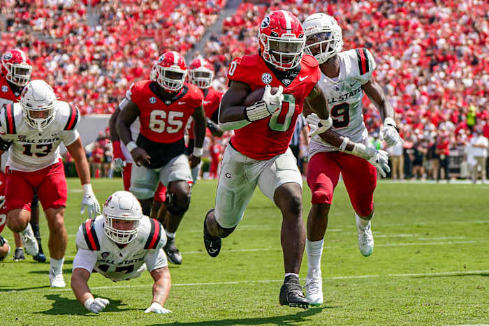 Sep 9, 2023; Athens, Georgia, USA; Georgia Bulldogs running back Roderick Robinson II (0) runs past Ball State Cardinals linebacker Keiont Newson (9) to score a touchdown against the Ball State Cardinals during the second half at Sanford Stadium.